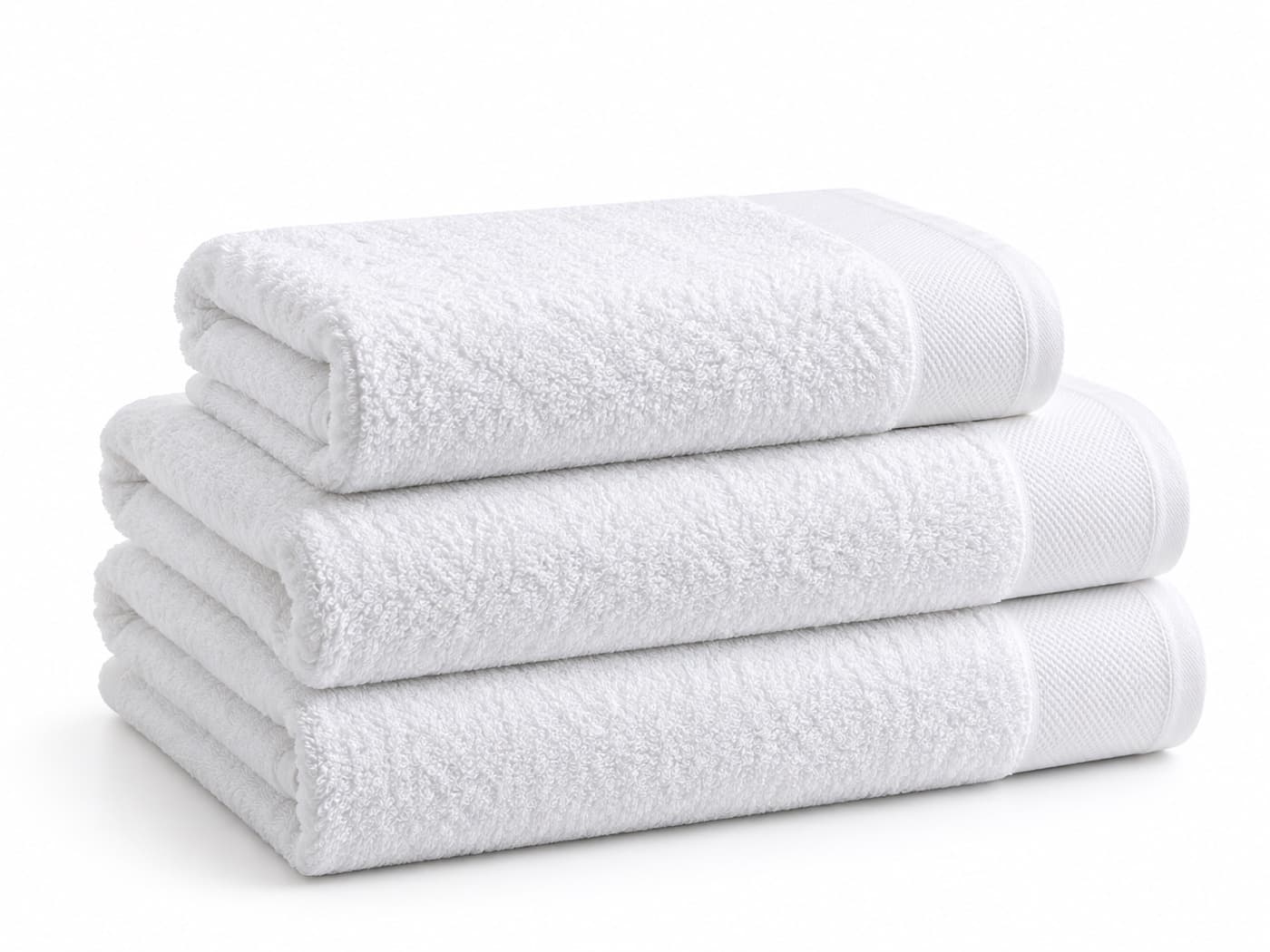Three folded white terry bath towels stacked